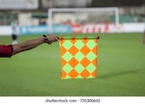 soccer-referee-hold-flag-offside-260nw-735300643.jpg